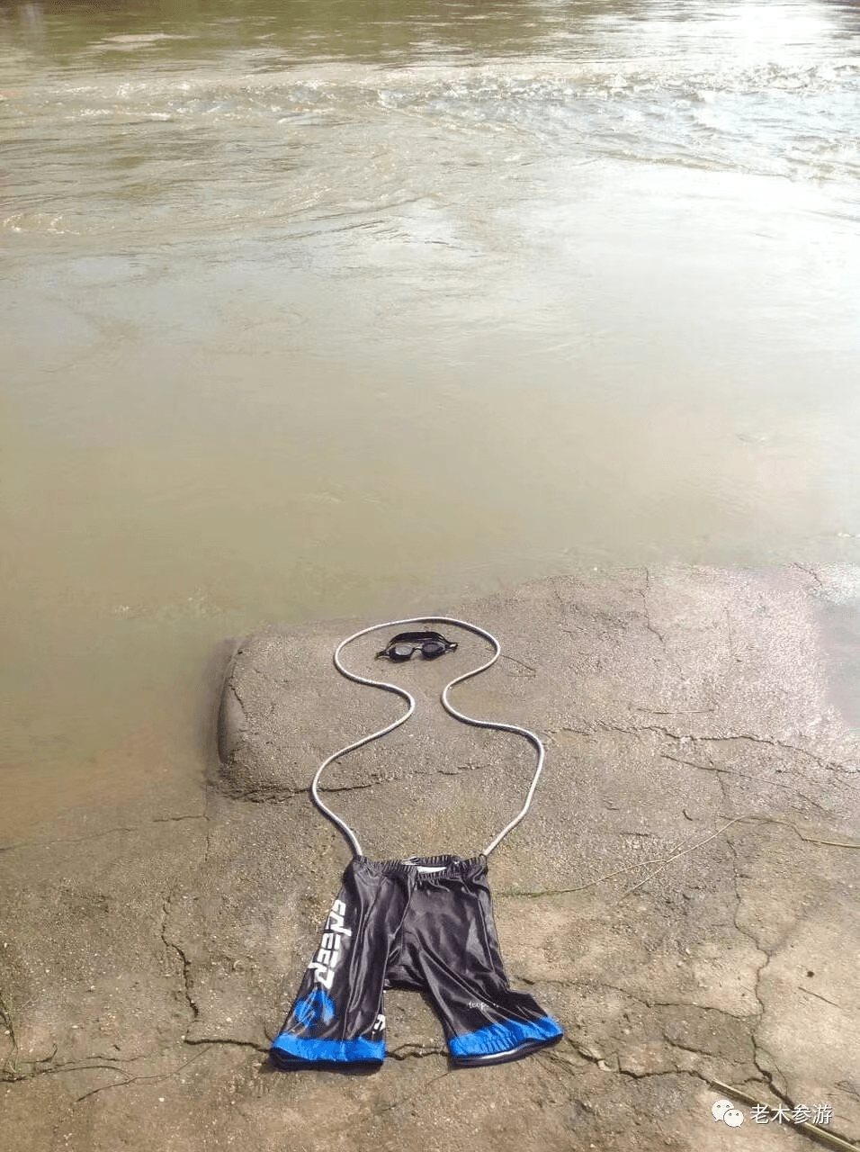 Swimming gear arranged on a riverbank — form as figure, figure as absence. From the Maska series.